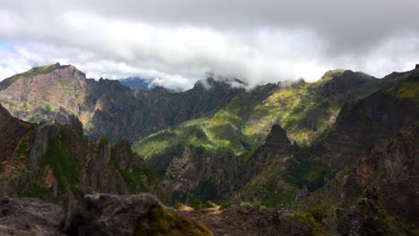 Dynamic-motion-timelapse-of-mountain-peaks-widescreen-view-high-altitude-adventure-cloudy-overcast-weather-walk-trekking-hiking-nature-natural-land-formation-volcanic-rocks-panoramic-180º-exposure