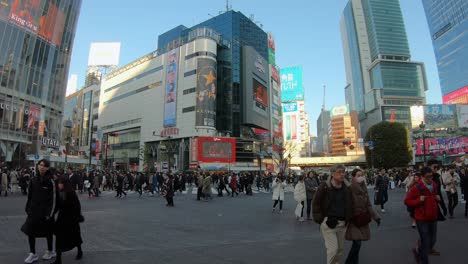 Commuters-Passing-Across-Shibuya-Scramble-In-Metropolitan-Tokyo,-Japan