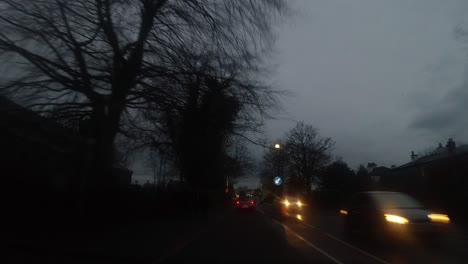 Dark,-rainy,-overcast-driving-hyperlapse,-traffic-headlights-moving-speeding-fast-in-cloudy-British-weather