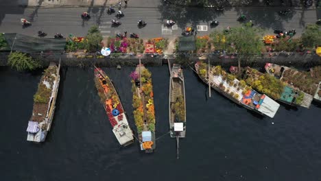 Aerial-tracking-view-of-floating-flower-market-and-activity-on-riverbank-in-Saigon-or-Ho-Chi-Minh-City-in-Vietnam