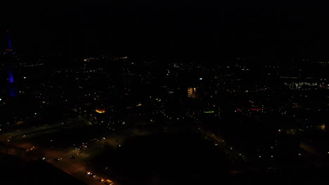 Night-aerial-drone-view-of-Elisa-communication-tower-in-Pasila,-Helsinki-Finland
