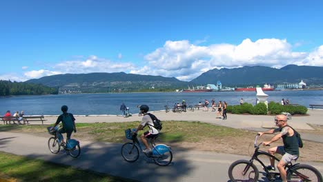 Men-riding-Mobi-Rental-bikes-on-a-waterfront-bike-trail-along-on-a-sunny-summer-day