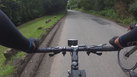 POV-Beside-Cyclist-Riding-Along-Nightingales-Lane-Road-Surrounded-By-Trees