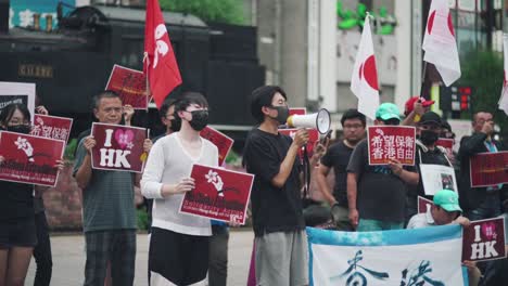 Japanese-Man-Speaking-Out-Through-A-Megaphone-With-The-Protesters-In-Tokyo,-Japan-During-A-Protest-In-Solidarity-With-Hong-Kong---medium-slowmo-shot