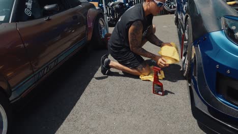 Woman-Cleaning-Her-Wheels-on-a-Subaru-STI-at-Car-Show