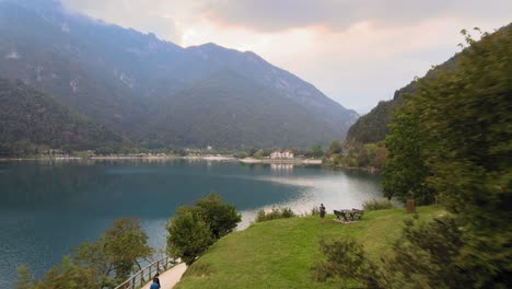 Aerial-view-on-resting-area-and-hiking-path-on-shore-of-Lake-Ledro,-Italy