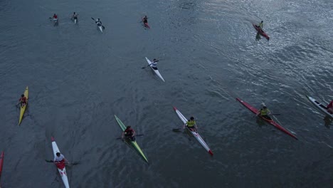 Aerial,-Group-of-People-Kayaking-Together-on-River-in-Dark-Blue-Evening-Light