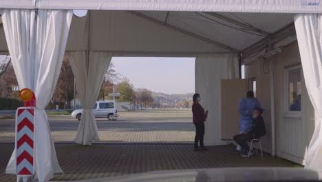 Covid-Sars-Cov-2-drive-through-corona-testing-station-with-doctor-taking-test-of-2-potentially-infected-patients-in-Germany