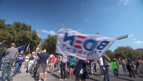 Female-Biden-supporter-waves-celebratory-banner-in-post-election-demonstration-in-Austin,-TX----4K