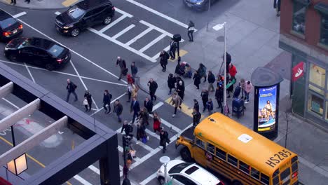 People-crossing-Canal-street-in-slow-motion-with-a-Santander-Bank-in-the-corner-during-the-COVID-19-Pandemic,-View-from-above