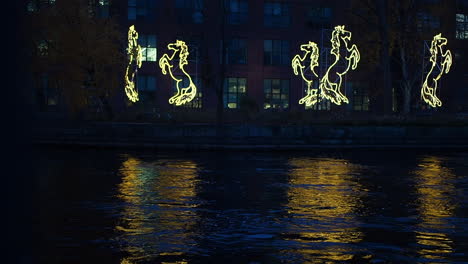 Office-building-illuminated-by-luminous-decorations-in-the-shape-of-horses