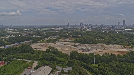 Atlanta-Georgia-Aerial-v625-pan-right-shot-of-forest,-skyline-and-sand-earthwork-at-Westside-Reservoir-Park---DJI-Inspire-2,-X7,-6k---July-2020