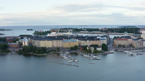 Slow-aerial-pan-of-Helsinki-waterfront-with-cruise-ship-and-ferris-wheel-in-frame,-Finland
