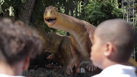 Kids-on-Elementary-School-Field-Trip-Look-On-at-Dinosaur-Exhibit,-LA-County-Fair,-Slow-Motion