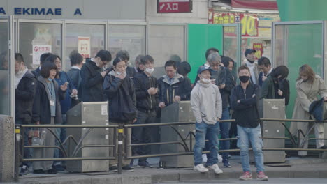 Car-Passed-By-People-Smoking-In-The-Designated-Smoking-Area-At-Shibuya-Crossing-During-Pandemic-In-Tokyo