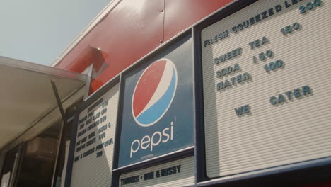 Menu-board-outside-of-street-vendor-at-outdoor-fesitval-in-summer