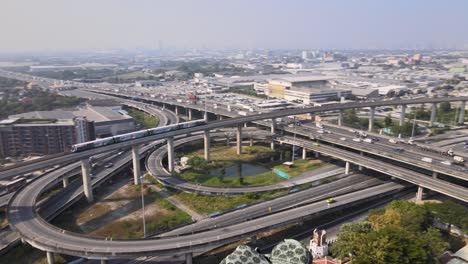 4k-BTS-Skytrain-goes-over-a-bridge-in-a-road-junction
