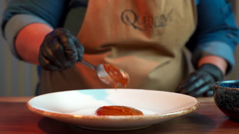 Chef-preparing-base-plate-for-pasta-with-tomato-sauce