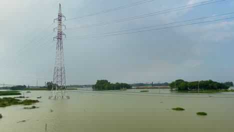 Establishing-shot-of-a-flooded-field-with-large-metal-pylons-in-the-centre-at-Sylhet