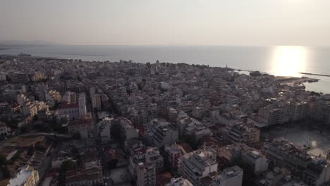 Panoramic-sunset-aerial-view-over-Patras-city-at-golden-hour,-Greece