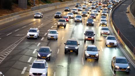 Multi-lane-highway-busy-car-traffic,-close-up-ar-dating-with-lights-on-panning-left