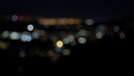 Nighttime-cityscape-in-Wellington,-slow-focus-pull-and-Bokeh-lighting-wide-shot
