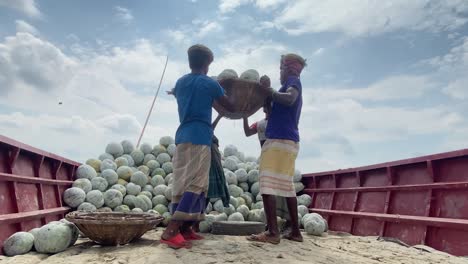Labors-Unloading-Ash-Gourd-In-Baskets-Out-Of-Big-Dock-In-Sunny-Day,-Dhaka,-Bangladesh