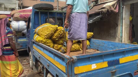 Hand-held-shot-of-workers-dropping-the-packed-produce-off-onto-the-bed-of-a-truck