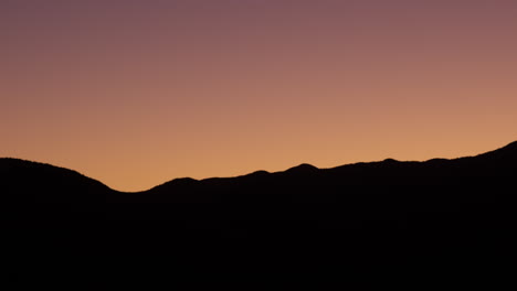 Scenic-summer-sunset-silhouette-over-the-mountains-in-Wellington,-New-Zealand