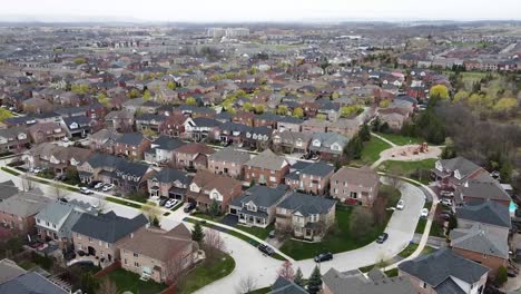 Drone-circling-over-overcast-Hamilton-suburb-in-the-spring