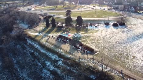 Drone-circling-flags-on-a-hillside-in-winter