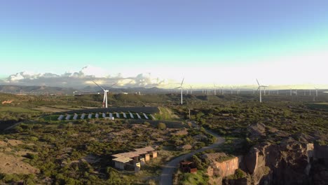 Green-energy,-beautiful-establisher-aerial-view-of-solar-panels-and-windturbines