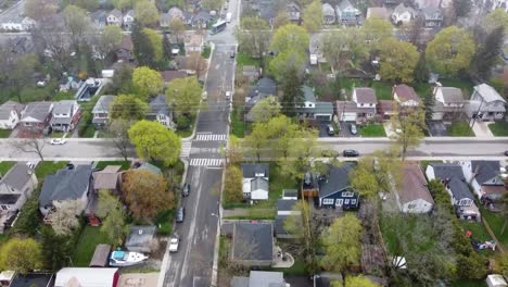 Top-down-aerial-shot-of-a-raining-and-foggy-suburban-neighborhood