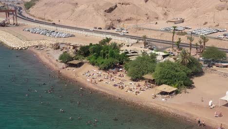 relaxing-and-swimming-near-coral-and-getting-tan-in-a-sunny-day-on-Moshe-beach-Eilat