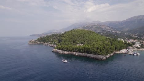 Aerial-of-boat-sailing-the-Albanian-Riviera-in-Himare-Ionian-Sea-Coast