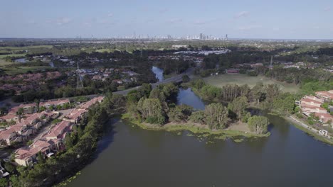 Mudgeeraba-Creek-Surrounded-By-Houses-And-Buildings-In-The-Town-Of-Robina-In-Queensland,-Australia