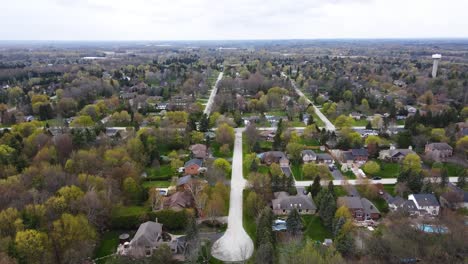 Aerial-shot-flying-towards-slightly-cloudy-neighborhood-in-spring-time-in-Hamilton