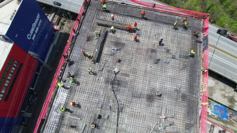 Drone-top-shot-Of-building-and-Construction-workers-on-Highrise