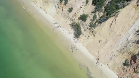 Aerial-View-Of-Coastal-Sand-Cliffs-And-Sandy-Shore-In-Rainbow-Beach,-Cooloola,-Queensland