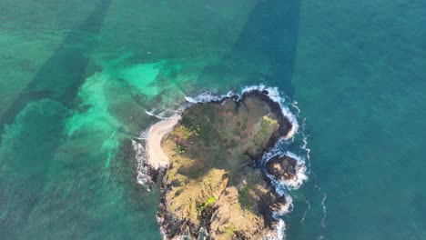 top-down-aerial-drone-clip-of-mokulua-island-in-lanikai-hawaii-then-panning-up-to-see-lanikai-beach-and-kailua-with-tall-mountains-in-oahu-hawaii