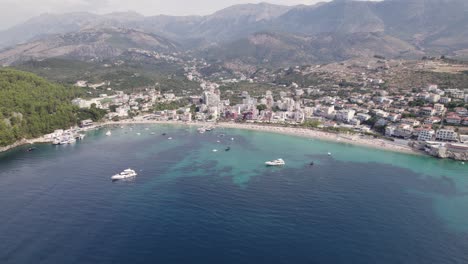 Wide-aerial-of-the-picturesque-azure-coastal-shore-of-Himare,-Albania