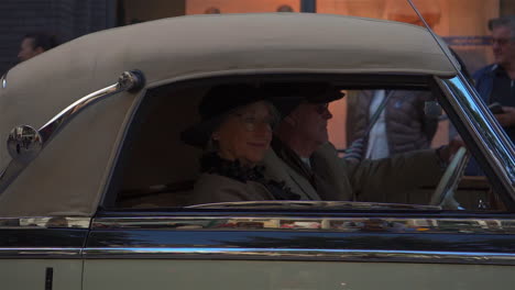 Elegant,-elderly-dutch-couple-driving-a-retro-vehicle-on-the-old-time-show-in-Zwolle,-Netherlands