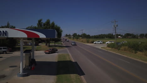 Drone-Shot-of-car-entering-Alon-Gas-Station-in-rural-Tulsa,-Oklahoma,-USA
