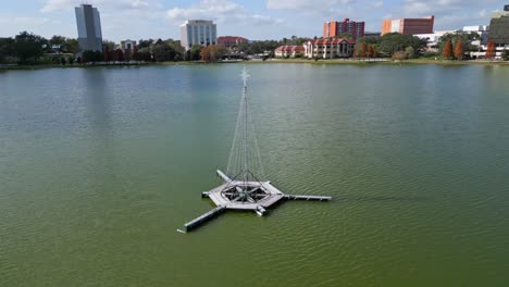 Christmas-tree-adorned-with-lights-in-the-center-of-Lake-Morton-in-downtown-Lakeland-Florida-during-the-holiday-season