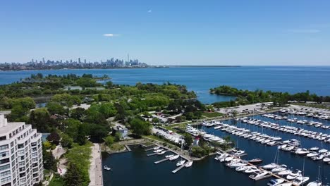 Drone-circling-over-sunny-summer-harbor-on-Lake-Ontario-near-Toronto