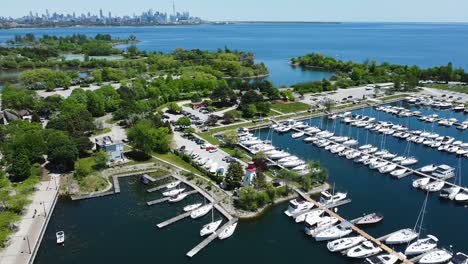 Aerial-shot-of-a-sunny-Toronto-harbor-filled-with-boats-on-Lake-Ontario