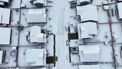 Overhead-aerial-shot-of-empty-streets-in-a-neighborhood-covered-in-snow