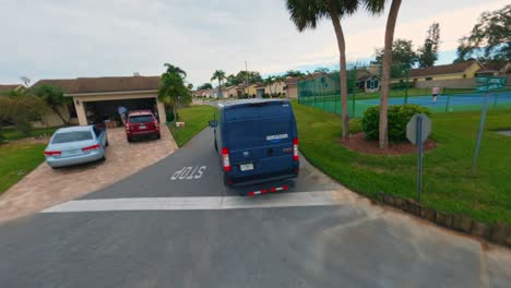 Amazon-prime-delivery-van-driving-through-nice-residential-Florida-neighborhood-near-Orlando-shot-by-an-FPV-drone-following-it-in-Winterhaven