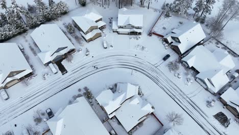 Drone-shot-of-snow-covering-a-residential-neighborhood