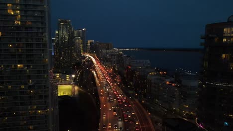 Drone-flying-over-Toronto's-Gardiner-Expressway-in-the-evening-with-lots-of-twilight-lights